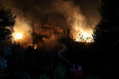 Members of emergency services work to contain a wildfire in Kalas, Delvina, Albania, July 27, 2025. REUTERS/Florion Goga      TPX IMAGES OF THE DAY     