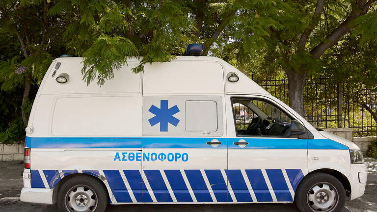 Crete.Greece - april 23, 2025: A white ambulance with official medical markings is parked on a city street. The blue star of life symbol indicates emergency medical response services available in the