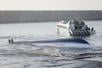 epa12285494 The capsized fastboat near Sanur Port in Bali, Indonesia, 06 August 2025. Two Chinese nationals are dead and one crew member is missing, while 77 have been rescued, after a tourist fast boat carrying 80 passengers traveling from Nusa Penida to Bali on 05 August capsized near Sanur Port, according to a statement issued by Bali's National Search and Rescue Agency (Basarnas).  EPA/MADE NAGI