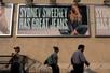 People walk past an American Eagle ad campaign featuring Sydney Sweeney in New York City, U.S., August 4, 2025. REUTERS/David 'Dee' Delgado