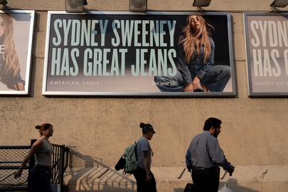 People walk past an American Eagle ad campaign featuring Sydney Sweeney in New York City, U.S., August 4, 2025. REUTERS/David 'Dee' Delgado