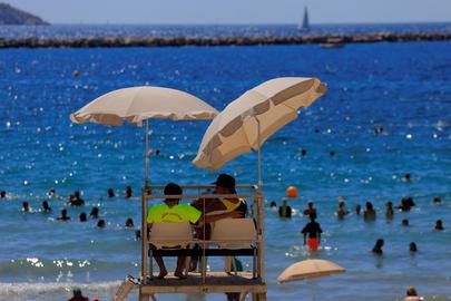 Lifeguards watch beachgoers as they bathe at the Beach of Catalans on a sunny and warm summer day in Marseille as an early summer heatwave hits France, July 1 , 2025. REUTERS/Manon Cruz