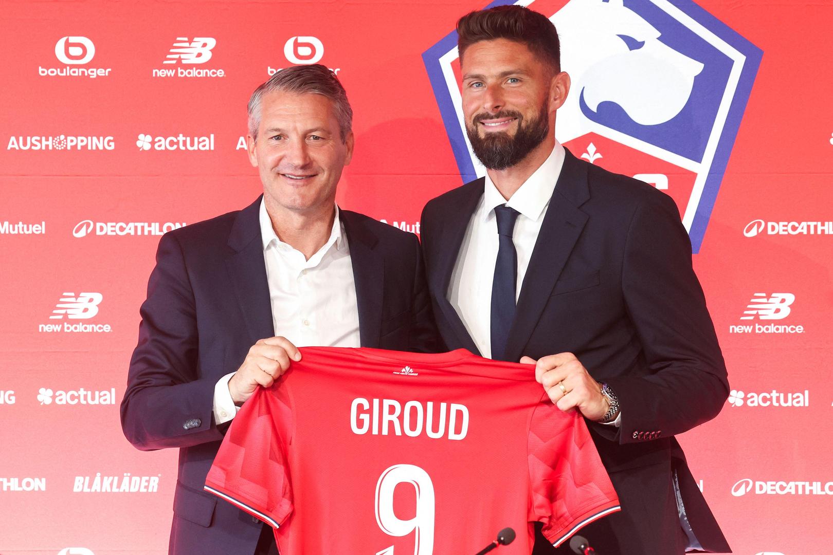 CORRECTION / Lille Olympique Sporting Club's (LOSC) president Olivier Letang poses with Lille's French forward #09 Olivier Giroud during a press conference to present the new recruits at the Domaine de Luchin (LOSC training centre) in Camphin-en-Pévèle, northern France, on July 2, 2025. (Photo by FRANCOIS LO PRESTI / AFP) / “The erroneous mention[s] appearing in the metadata of this photo by FRANCOIS LO PRESTI has been modified in AFP systems in the following manner: [July] instead of [June]. Please immediately remove the erroneous mention[s] from all your online services and delete it (them) from your servers. If you have been authorized by AFP to distribute it (them) to third parties, please ensure that the same actions are carried out by them. Failure to promptly comply with these instructions will entail liability on your part for any continued or post notification usage. Therefore we thank you very much for all your attention and prompt action. We are sorry for the inconvenience this notification may cause and remain at your disposal for any further information you may require.”